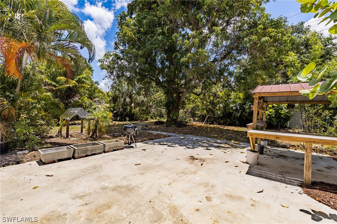 1806 Coronado Road Fort Myers, FL 33901 - Photo 18 of 23 a view of patio with chairs and wooden fence