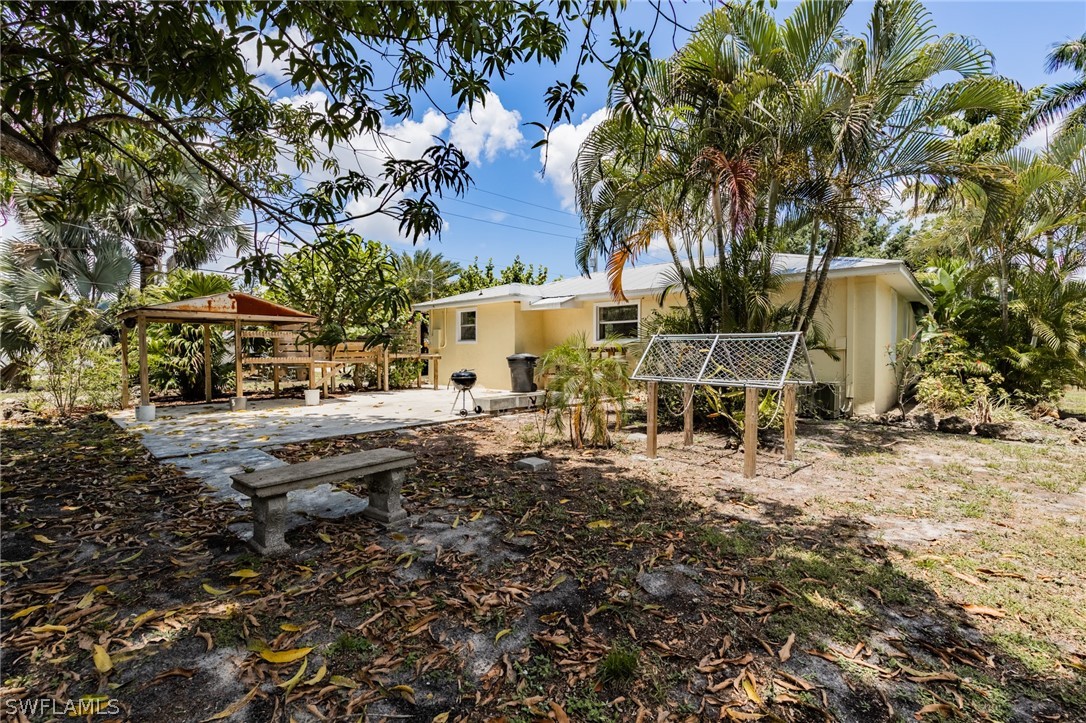 1806 Coronado Road Fort Myers, FL 33901 - Photo 19 of 23 a backyard of a house with lots of green space