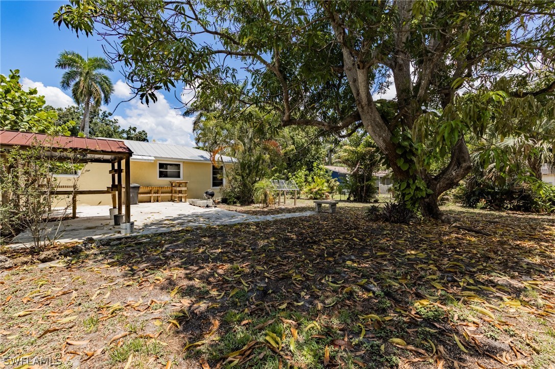 1806 Coronado Road Fort Myers, FL 33901 - Photo 20 of 23 a backyard of a house with lots of green space