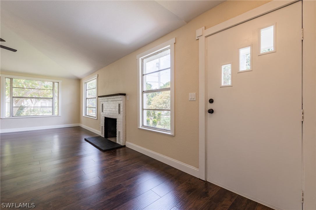 1806 Coronado Road Fort Myers, FL 33901 - Photo 3 of 23 a view of an empty room with wooden floor and a window