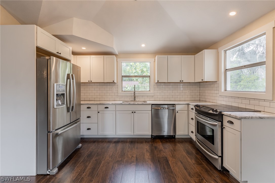 1806 Coronado Road Fort Myers, FL 33901 - Photo 8 of 23 a kitchen with granite countertop stainless steel appliances a stove sink and refrigerator