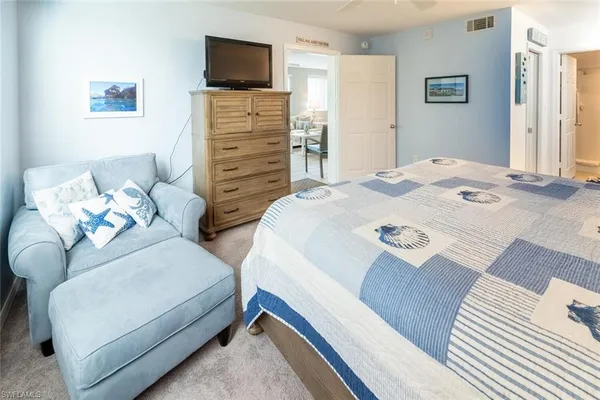 a bedroom with two beds and a flat screen tv