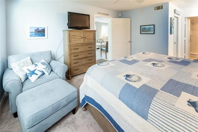 a bedroom with two beds and a flat screen tv