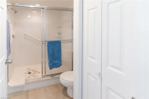 a bathroom with a shower and a toilet
