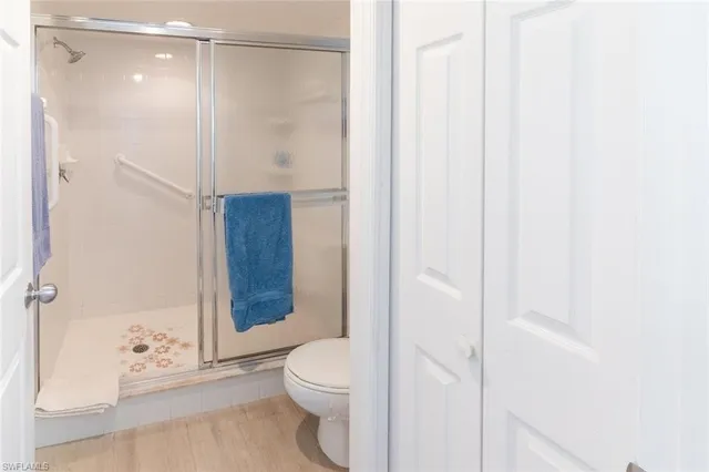 a bathroom with a shower and a toilet