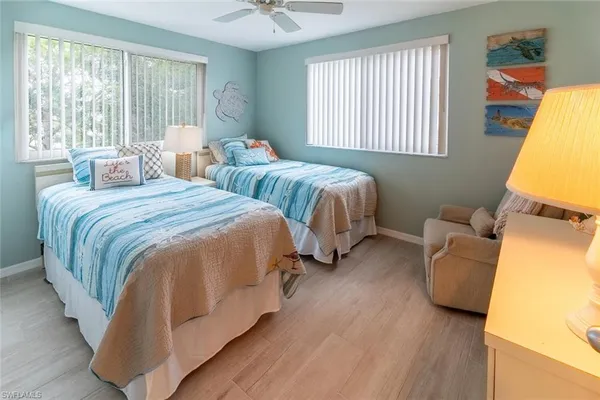 a bedroom with two beds and a window