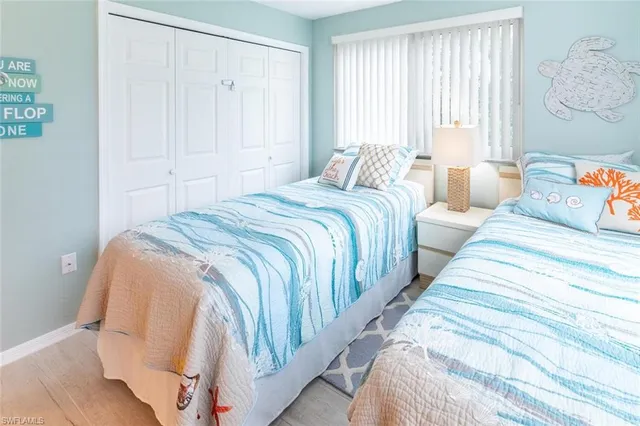 a bedroom with beds and a window