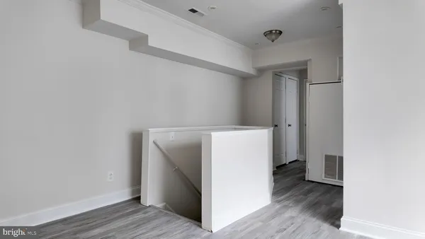 a utility room with wooden floor washer and dryer