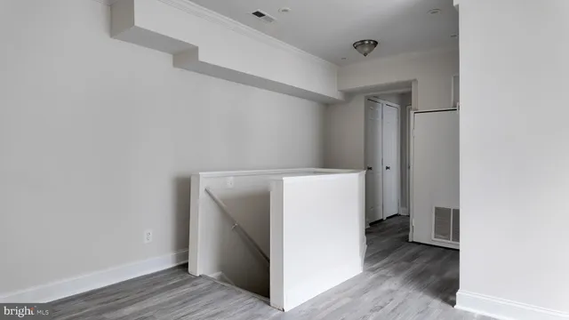a utility room with wooden floor washer and dryer