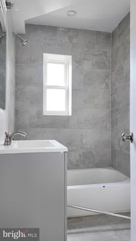 a bathroom with a bathtub and a sink