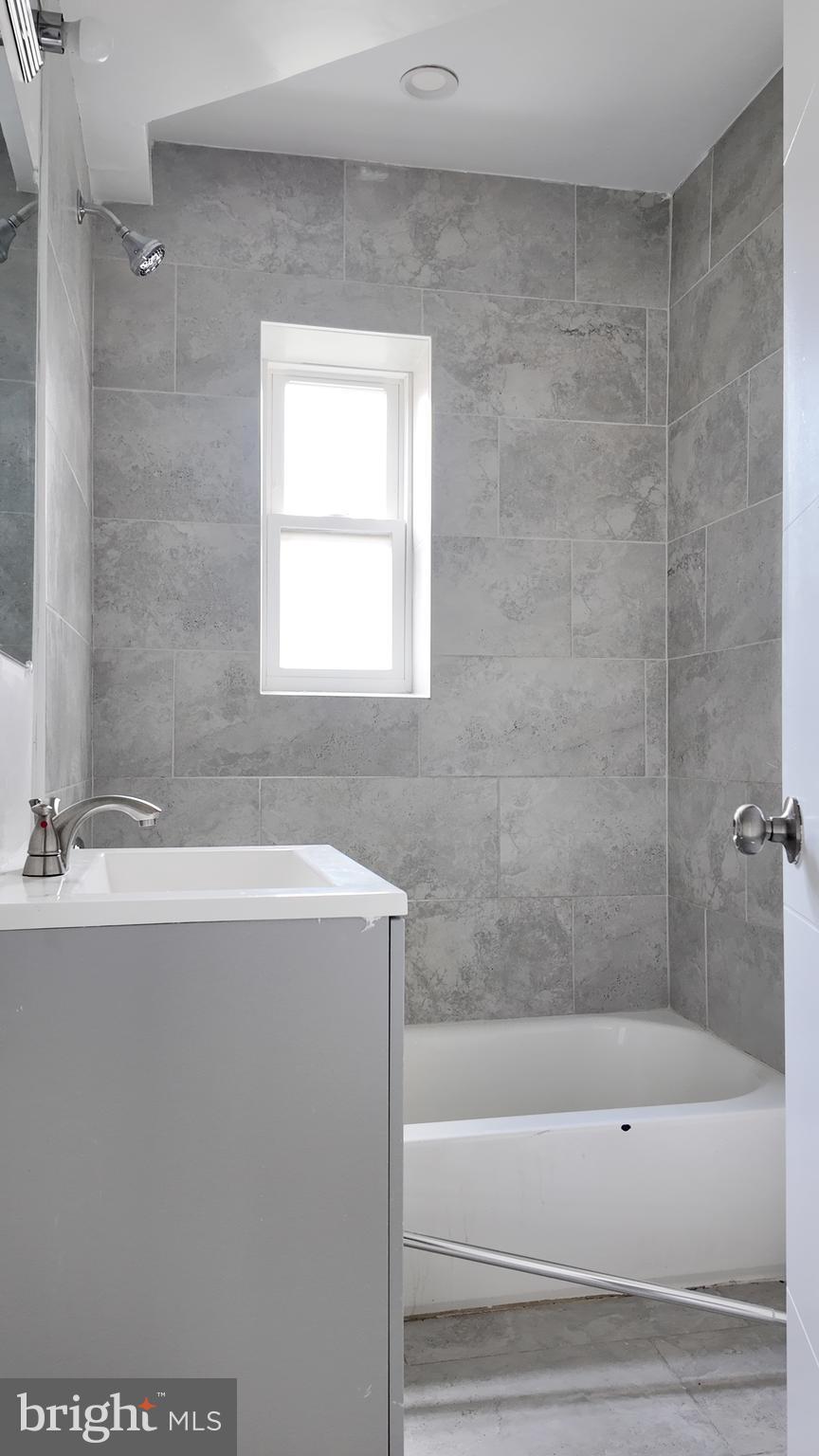 4306 Halley Terrace Southeast, Unit 1 Washington, DC 20032 - Photo 5 of 9 a bathroom with a bathtub and a sink