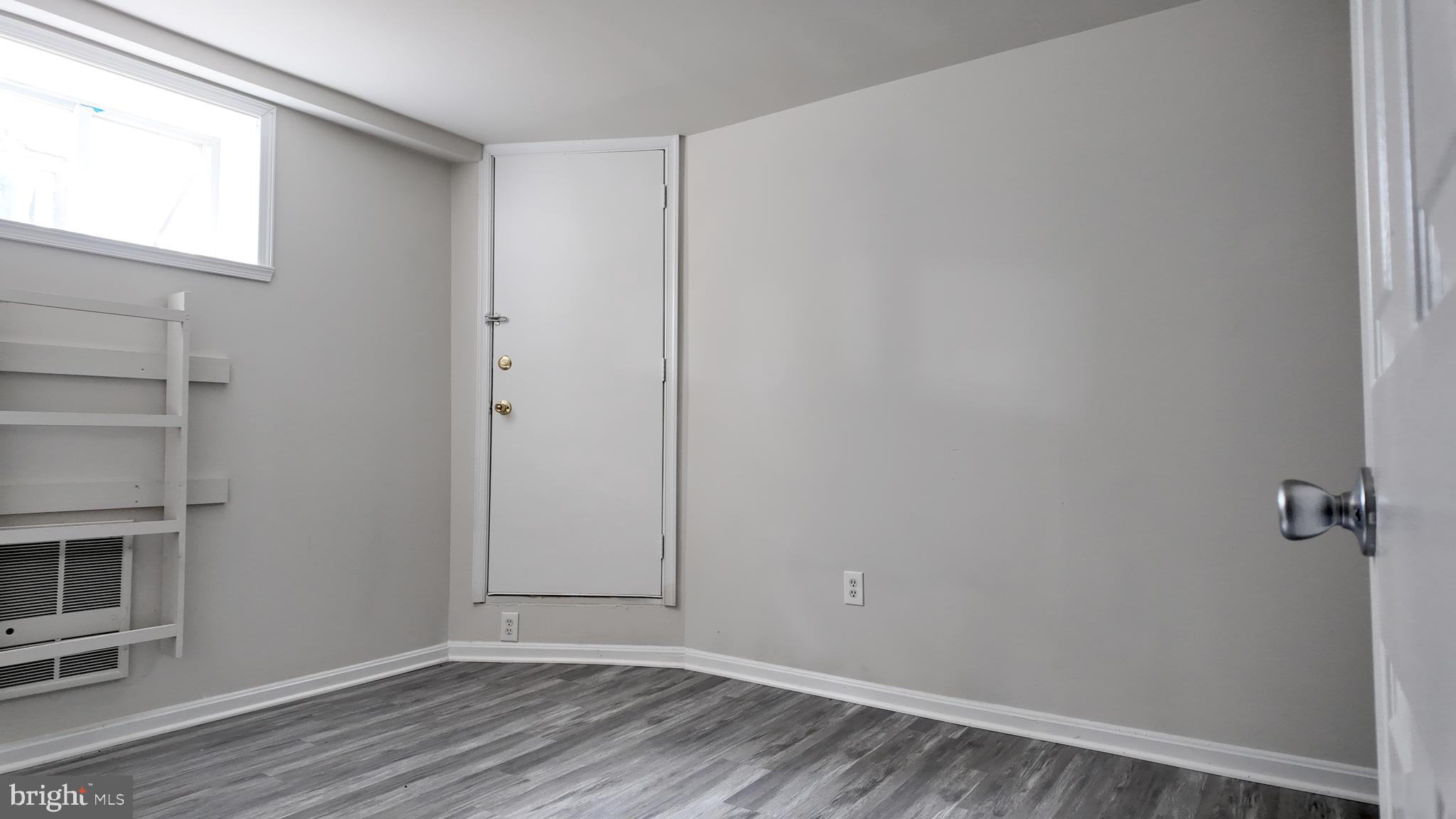 4306 Halley Terrace Southeast, Unit 1 Washington, DC 20032 - Photo 9 of 9 a view of an empty room with wooden floor and a window