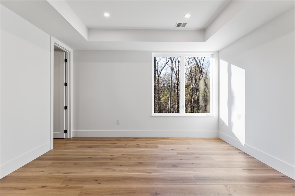 531 Annursnac Hill Road Concord, MA 01742 - Photo 18 of 27 a view of an empty room with wooden floor and a window