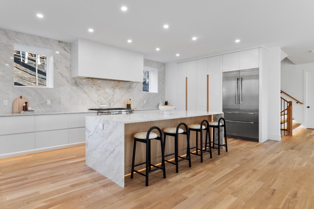 531 Annursnac Hill Road Concord, MA 01742 - Photo 4 of 27 a kitchen with kitchen island granite countertop a refrigerator and a stove top oven