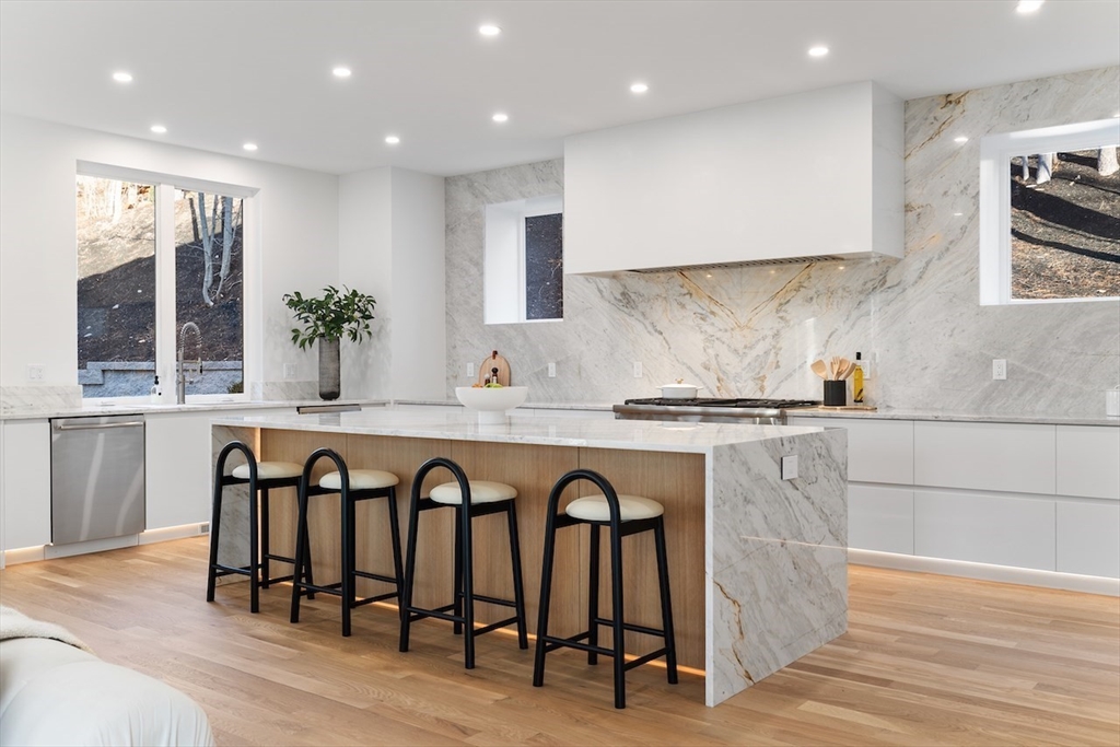531 Annursnac Hill Road Concord, MA 01742 - Photo 5 of 27 a kitchen with stainless steel appliances granite countertop a table and chairs in it