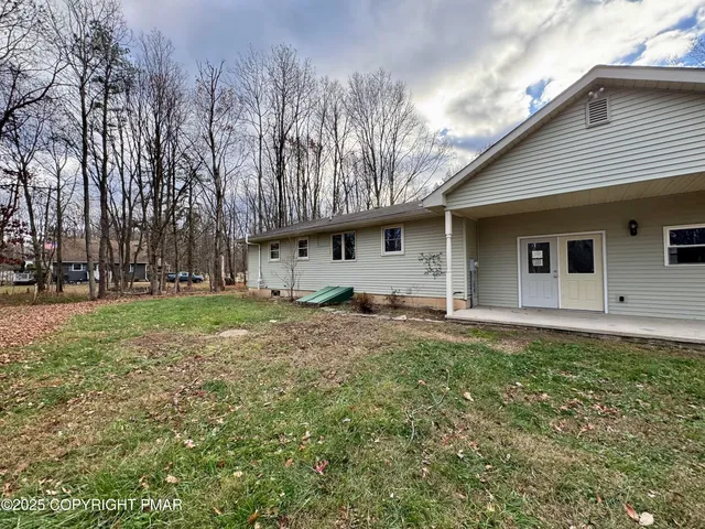 a backyard of a house with lots of green space