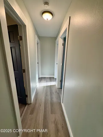 an entryway with wooden floor