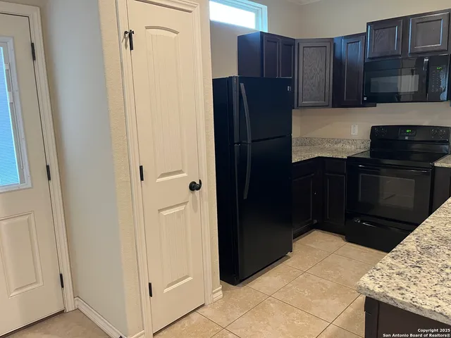 a kitchen with a sink vanity and a mirror