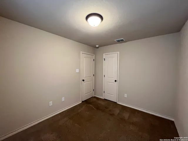 an empty room with a empty space and windows