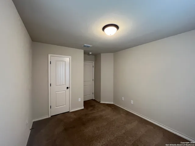 a bathroom with a granite countertop sink and a toilet