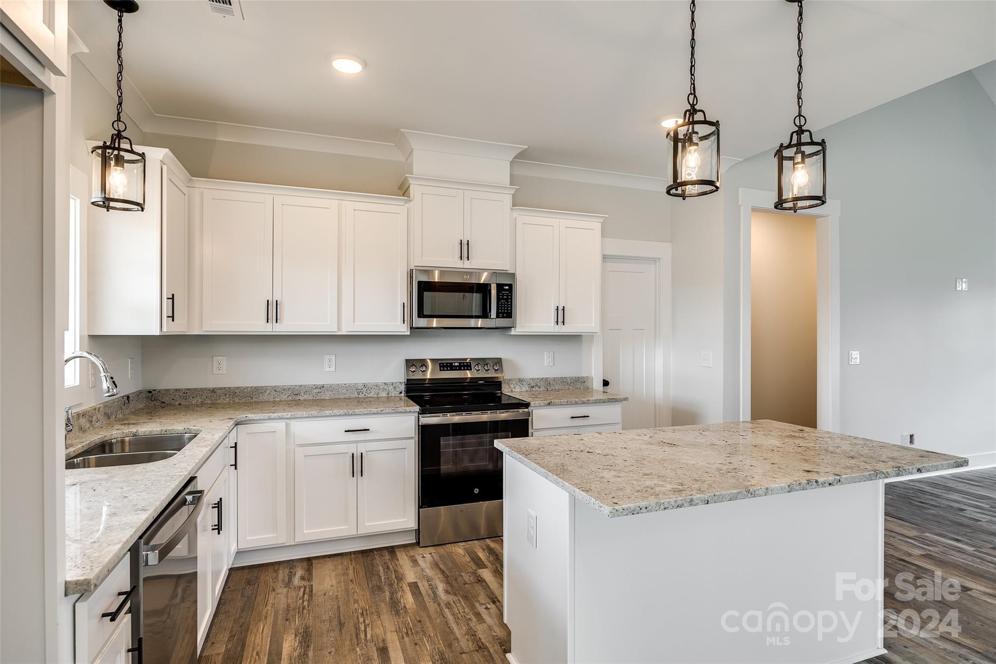 1186 Philbeck Road York, SC 29745 - Photo 11 of 35 a kitchen with granite countertop a sink a counter space appliances and cabinets