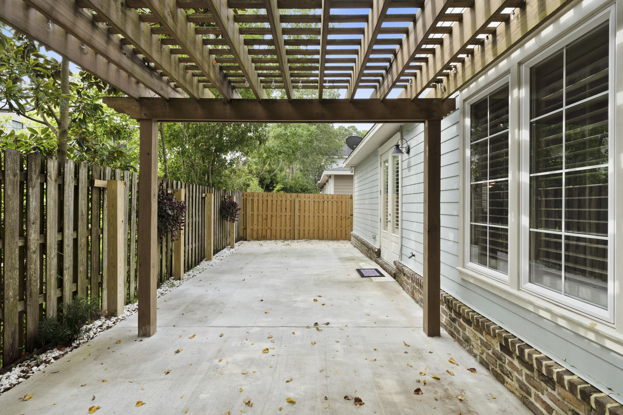 17 South Zander Way Santa Rosa Beach, FL 32459 - Photo 36 of 44 a backyard of a house with large trees and a wooden fence