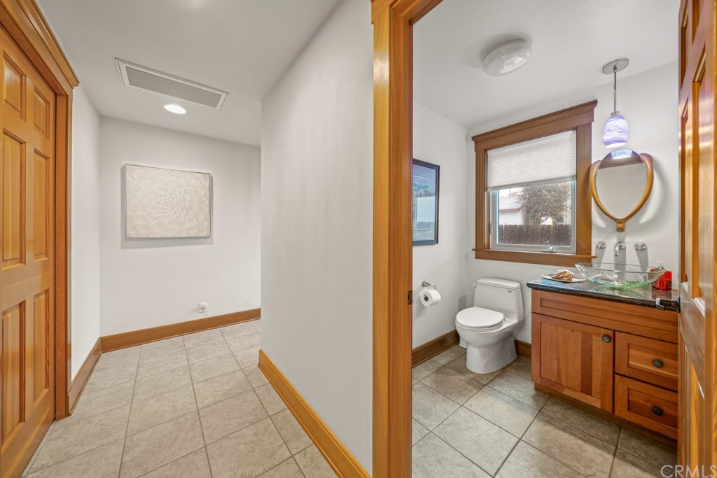 218 14th Street Seal Beach, CA 90740 - Photo 13 of 44 Main floor powder room and hallway Chef's pantry, laundry room, and attached garage