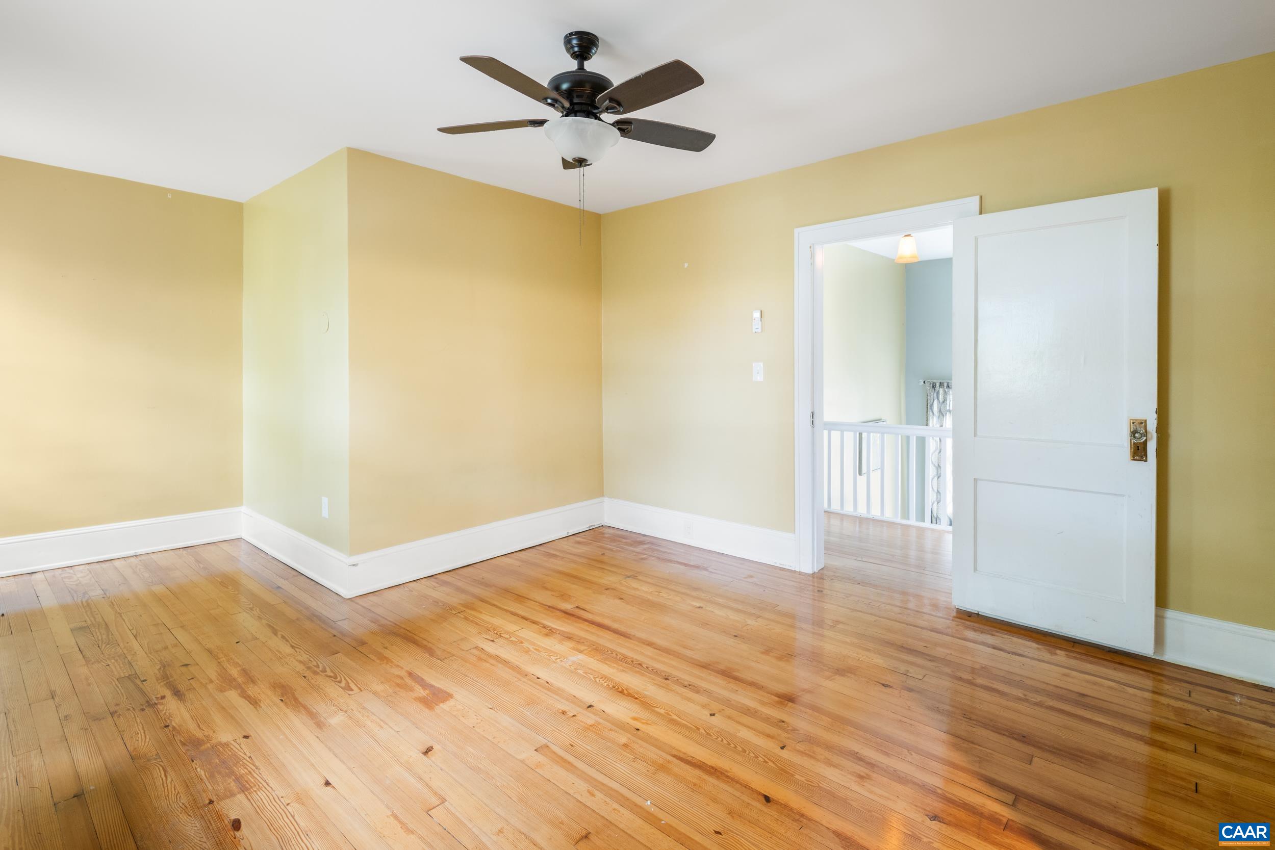 21 Port Republic Road Harrisonburg, VA 22801 - Photo 30 of 69 a view of an empty room with wooden floor and a ceiling fan