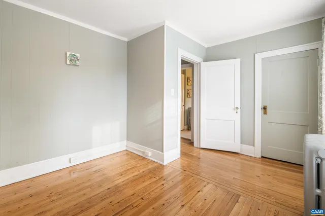 a view of an empty room with window and closet
