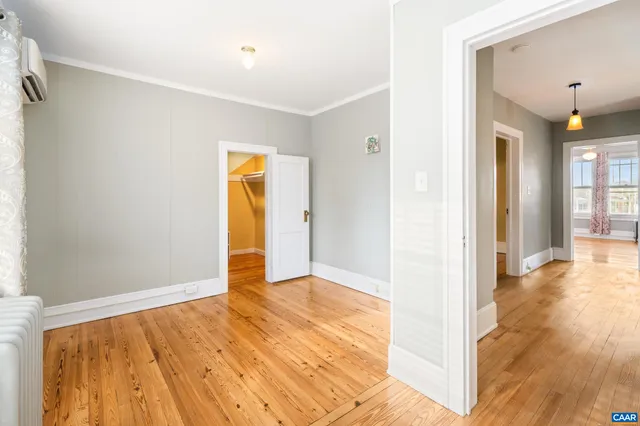an empty room with kitchen view
