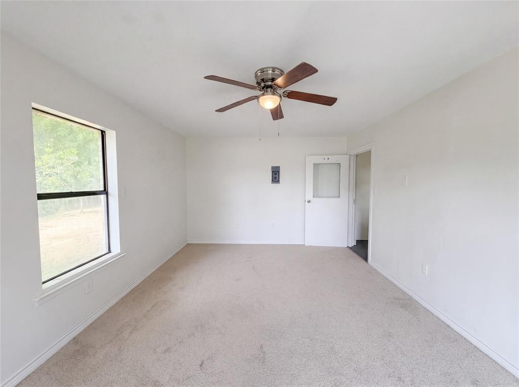 205 West Decatur Street Chico, TX 76431 - Photo 10 of 19 a view of room with a ceiling fan and window