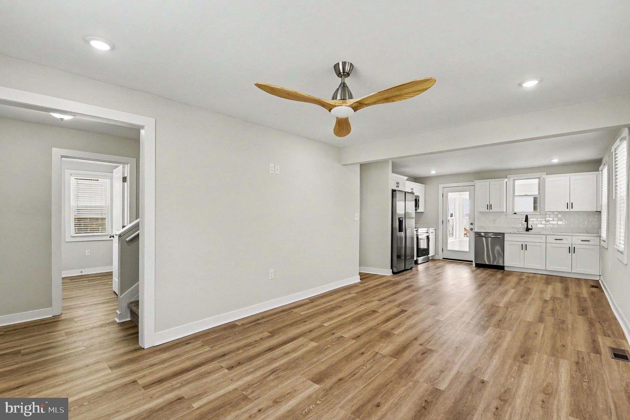 9135 Cuckold Point Road Sparrows Point, MD 21219 - Photo 13 of 44 a view of a livingroom with wooden floor and a ceiling fan