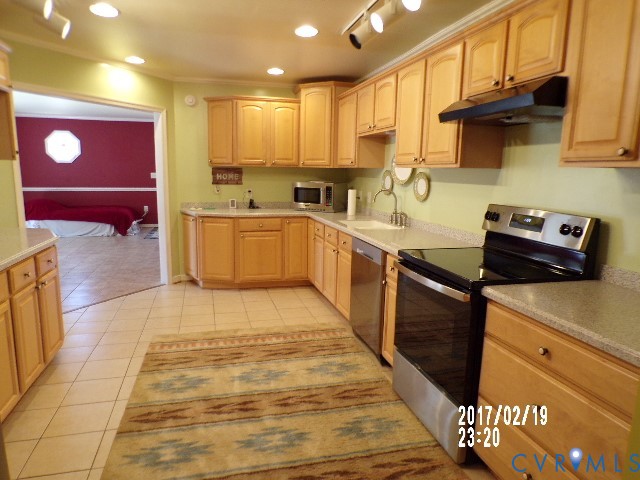 14105 Bethany Church Road Montpelier, VA 23192 - Photo 11 of 20 a kitchen with stainless steel appliances granite countertop a stove a sink and a microwave