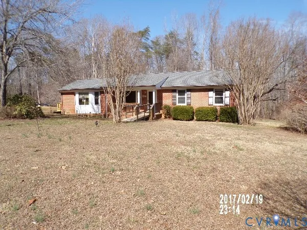 a front view of house with yard and trees
