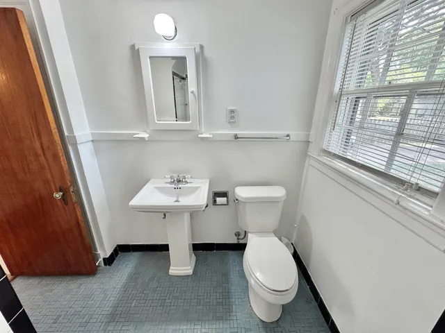 a bathroom with a sink a toilet and mirror