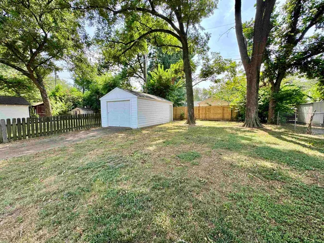 a white house that has a tree in front of it
