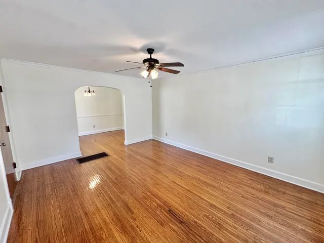 wooden floor in an empty room with a window