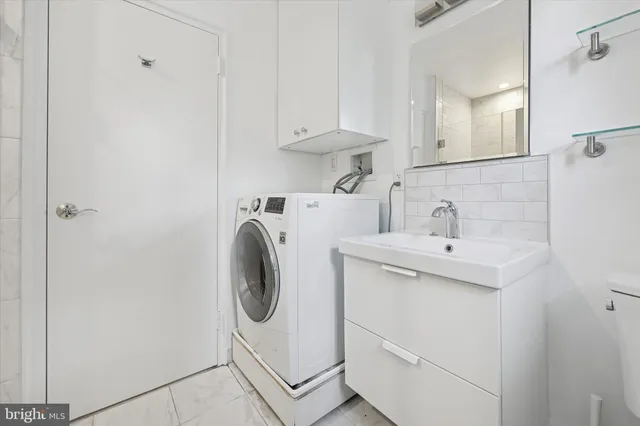 a utility room with sink dryer and washer