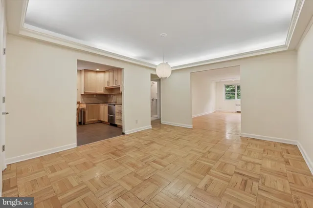 a view of empty room with wooden floor
