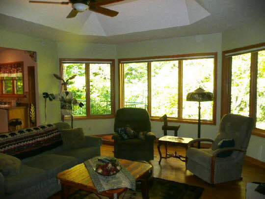 3328 South Seldom Scene Road Oregon, IL 61061 - Photo 6 of 11 a living room with furniture and a floor to ceiling window