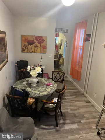 a dining room with furniture and wooden floor