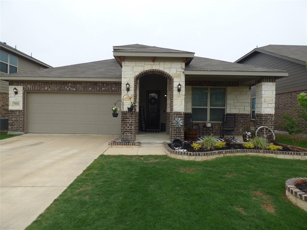a front view of a house with a garden and sitting area