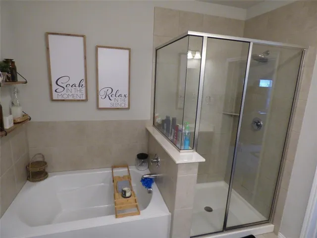 a bathroom with a tub and shower