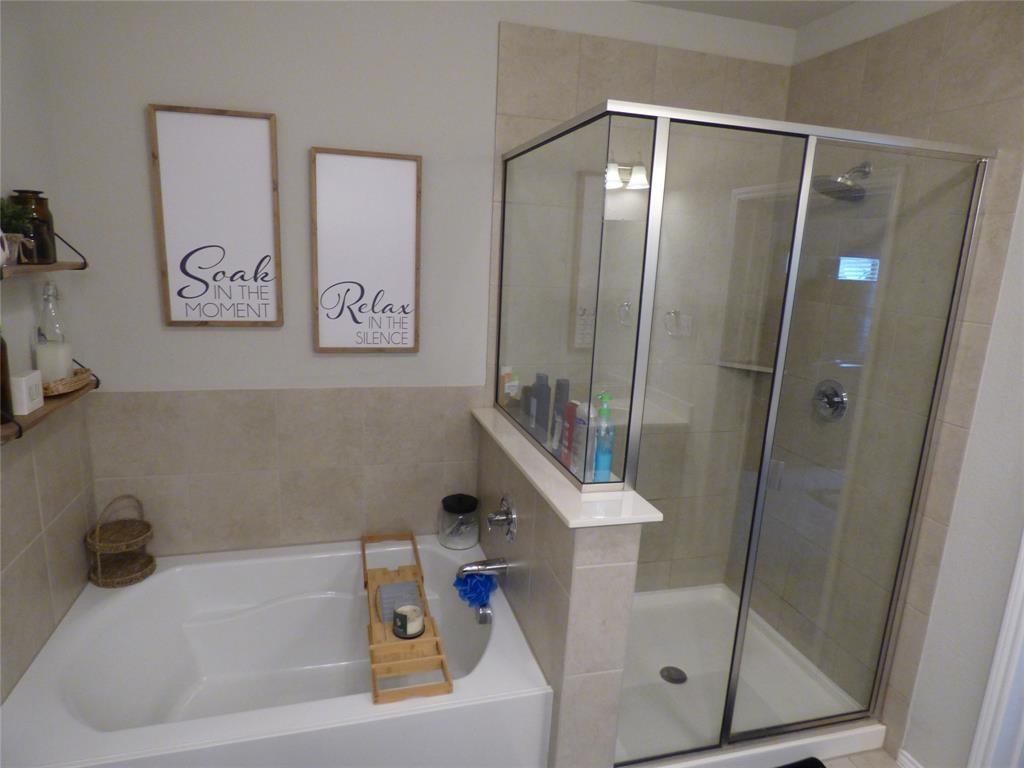 7416 Boat Wind Road Fort Worth, TX 76179 - Photo 18 of 18 a bathroom with a tub and shower