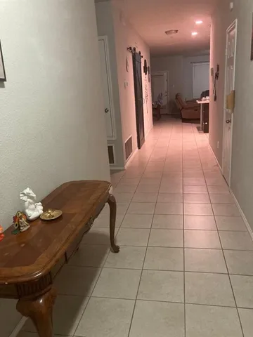 a view of kitchen with furniture and a refrigerator
