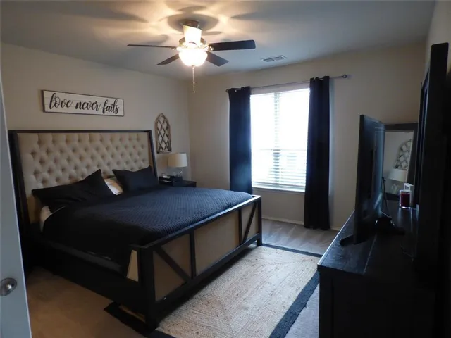 a bed sitting in a bedroom next to a window