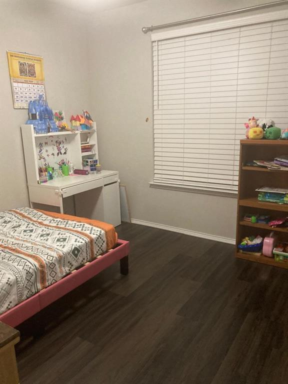 7416 Boat Wind Road Fort Worth, TX 76179 - Photo 6 of 18 a bed sitting in a bedroom next to a window