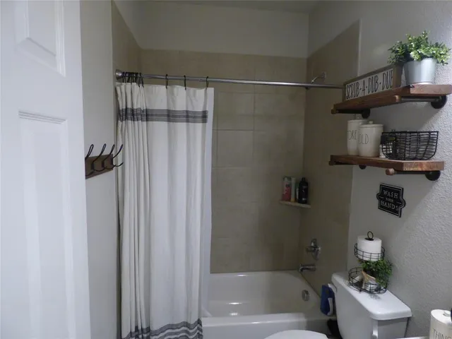 a bathroom with a shower curtain and a sink