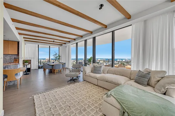a living room with furniture and large windows