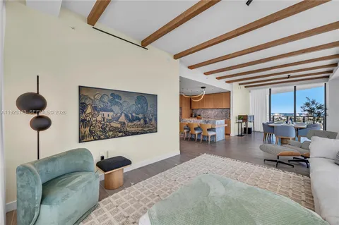 a living room with furniture wooden floor and a table